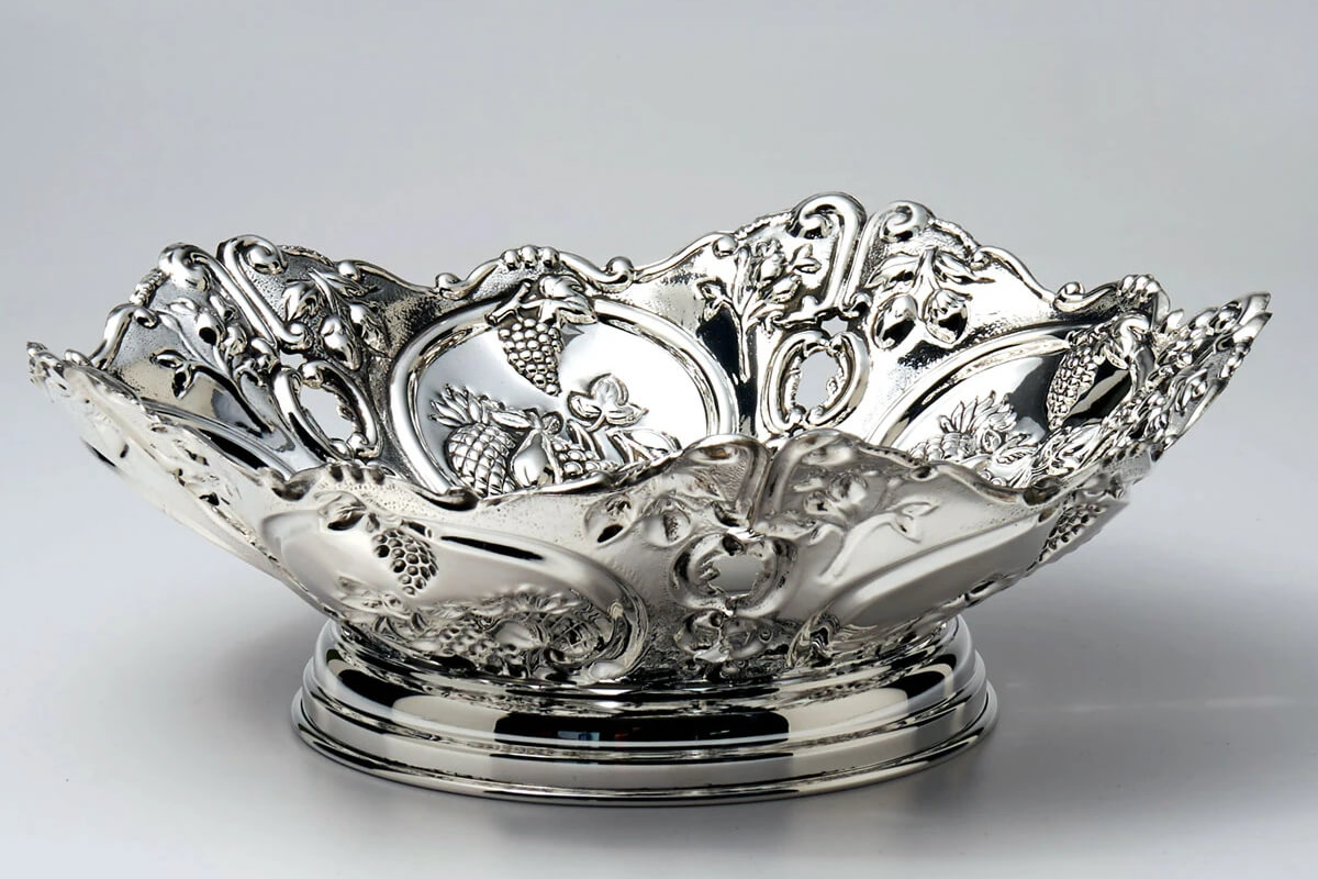 a silver bowl with ornate designs on it